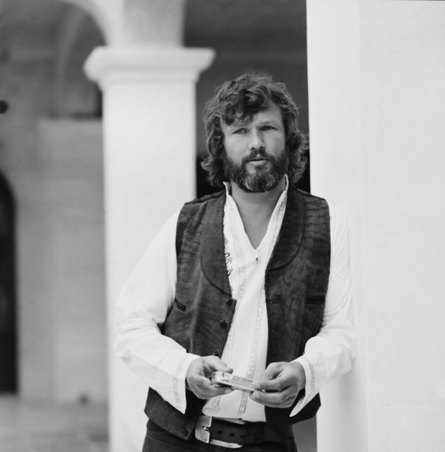 Kris Kristofferson leaning against a wall