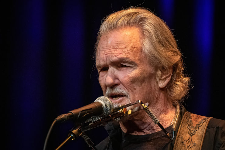 Kris Kristofferson singing into a microphone