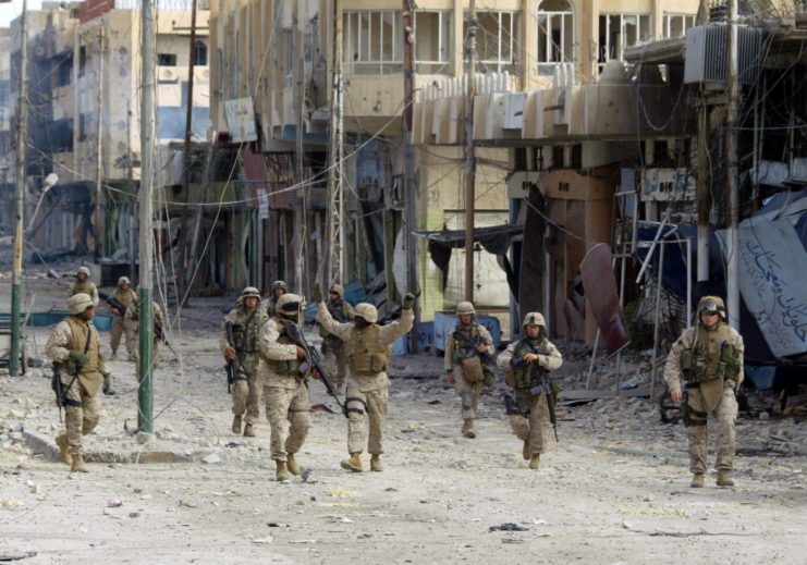 US Marines celebrating while walking down a street in Fallujah