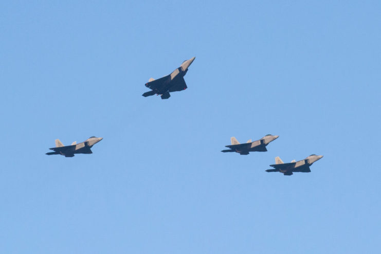 Four aircraft flying in a missing man formation