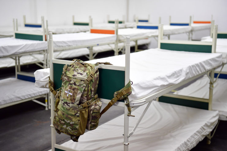 Backpack hanging off the side of a bunkbed