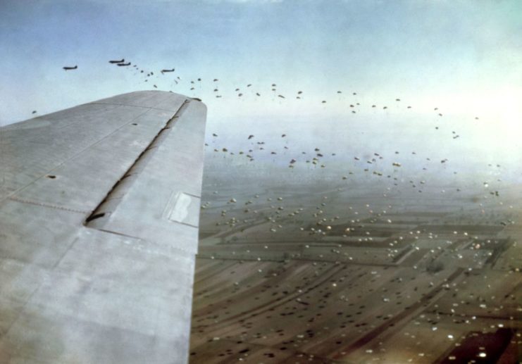 Paratroopers floating to the ground after jumping out of a Douglas C-47 Dakota
