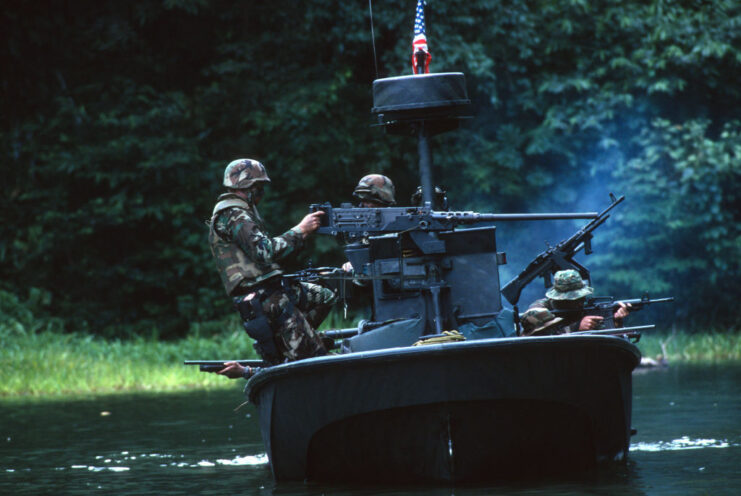 US Navy Special Boat-26 (SBU-26) members firing an M2 Browning .50 caliber heavy machine gun