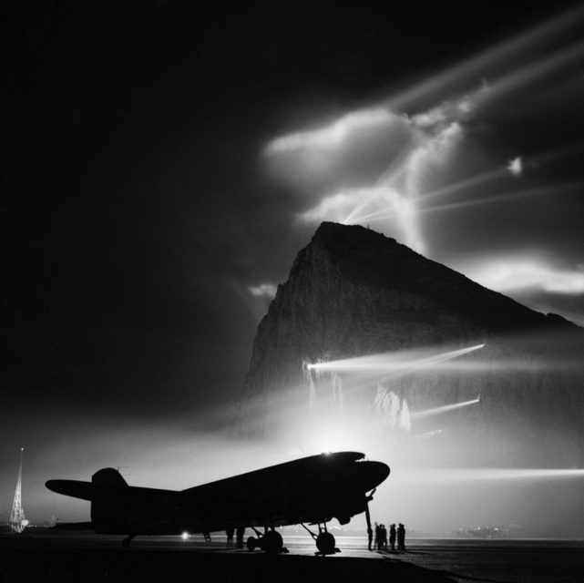 Douglas C-47 Dakota parked on a runway at night