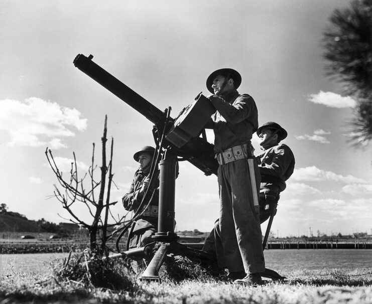 Three soldiers with the 62nd Coast Artillery manning an M2 Browning .50 caliber heavy machine gun