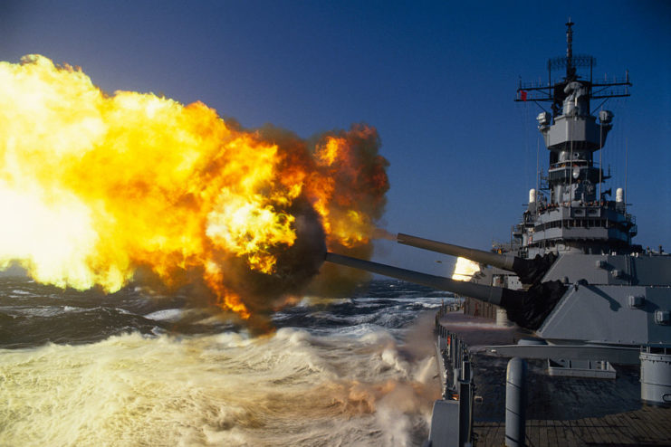 Cannons firing off the side of the USS Iowa (BB-61)