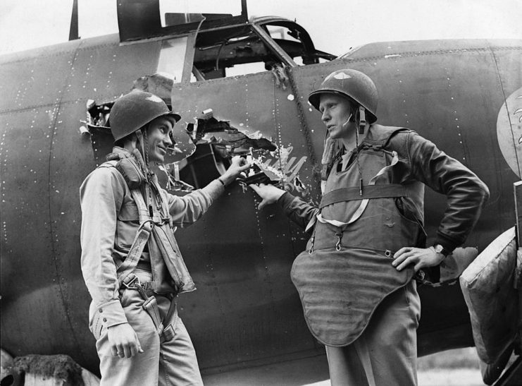 Tom Trainer and Jim Davis standing next to the damaged Martin B-26 Marauder Miss Emily