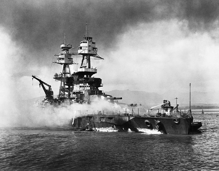 Smoke billowing from the deck of the USS Nevada (BB-36)