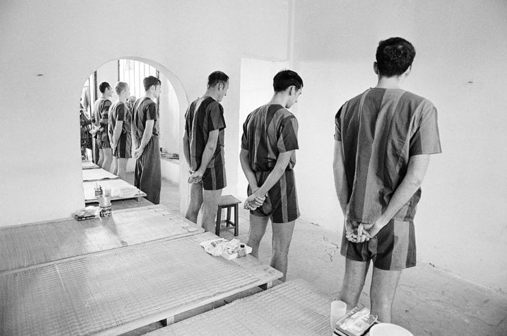American prisoners of war (POWs) standing in front of their beds