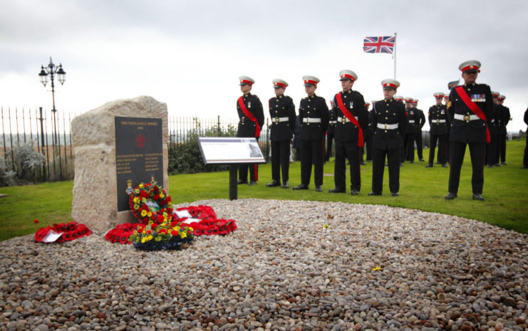 Royal Marine cadets standing near the memorial to the Cockleshell Heroes
