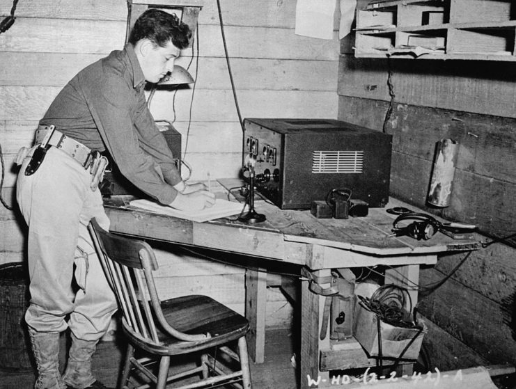 Joseph L. Lockard leaning over a radio