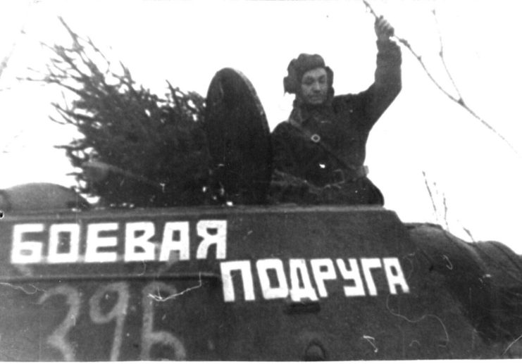 Mariya Oktyabrskaya standing in the hatch of a T-34 tank