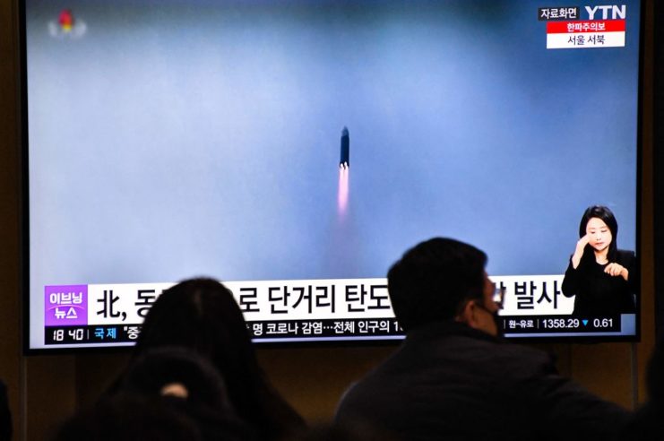 South Koreans watching footage of a missile test by North Korea