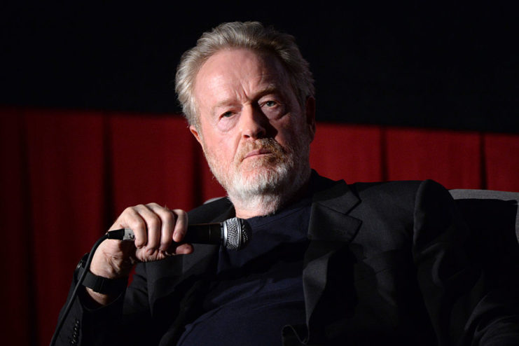 Ridley Scott holding a microphone