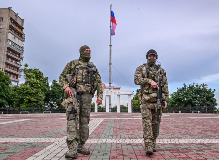 Two Russian soldiers standing together outside
