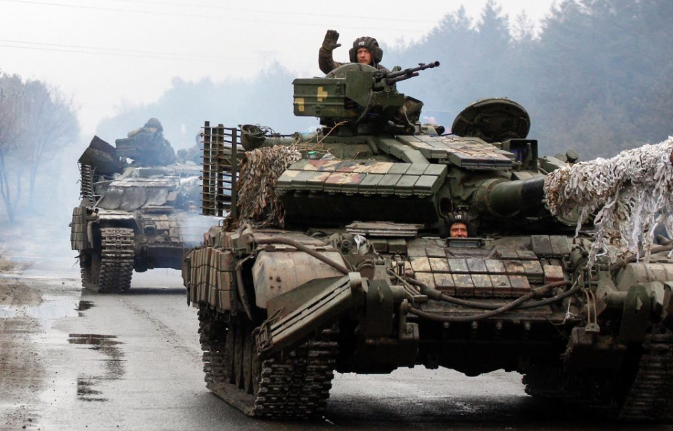 Convoy of Ukrainian tanks driving down a road