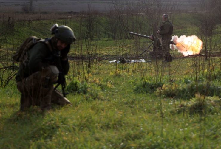 Ukrainian soldiers firing weapons outside