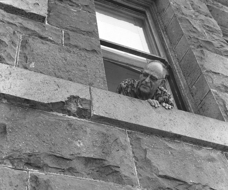 Dan Pires looking out a window at Punahou School