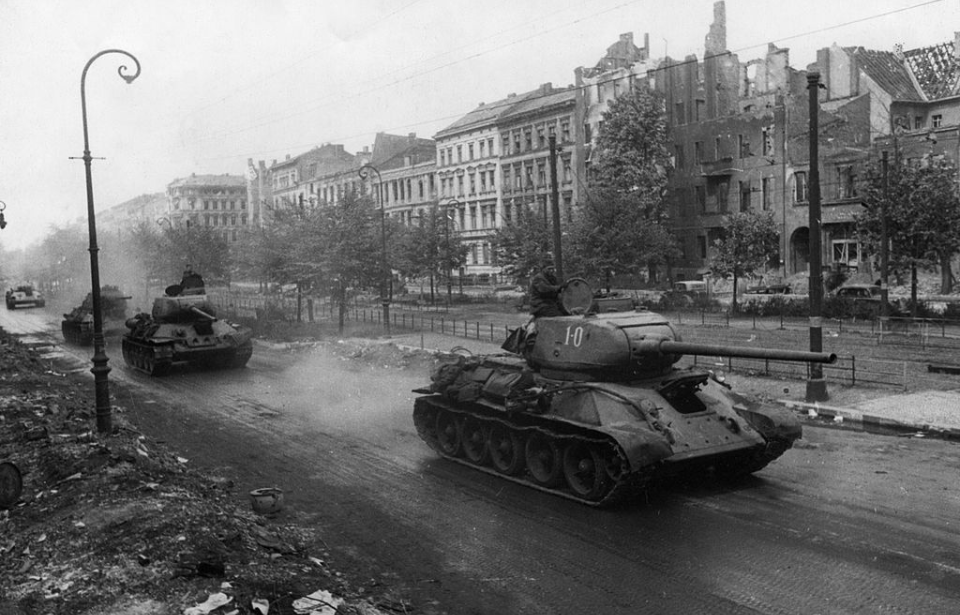 Fleet of T-34s driving down a street in Berlin