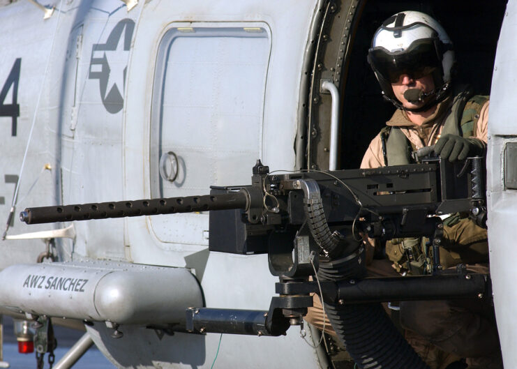 Aviation Warfare Systems Operator 3rd Class Ryan Branco manning an M2 Browning .50 caliber heavy machine gun