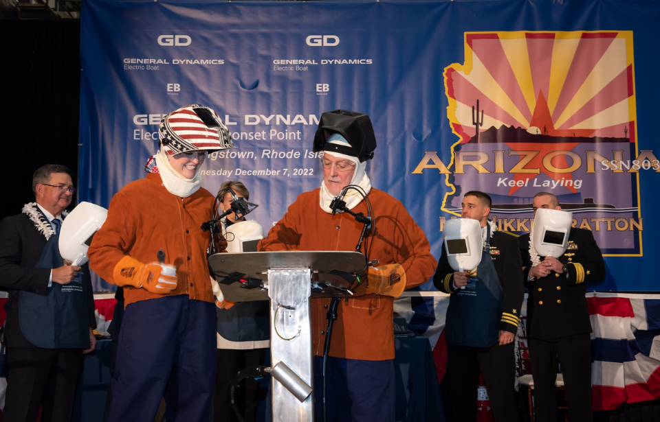 Nikki Stratton and Bob Hobday standing at a podium