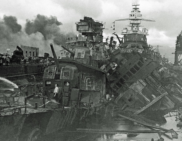 US Navy personnel examining the damage caused to the USS Downes (DD-375) and Cassin (DD-372)