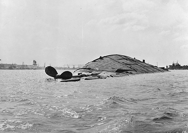 Capsized USS Oklahoma (BB-37) in the water at Pearl Harbor