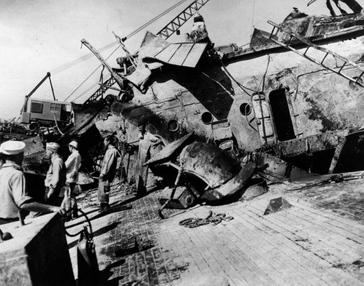 Salvage crews on the deck of the capsized USS Oklahoma (BB-37)