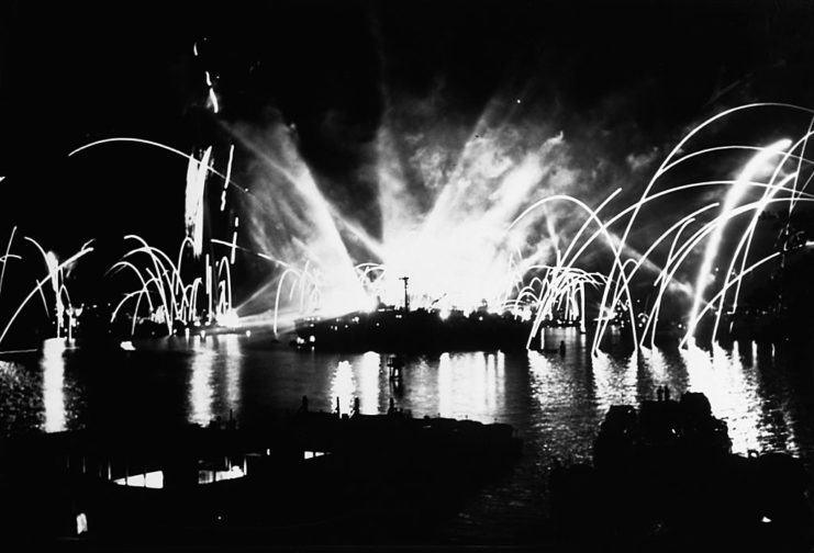 Fireworks being set along the coast of Pearl Harbor