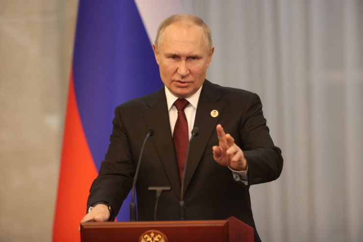 Vladimir Putin speaking at a podium