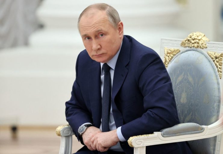 Vladimir Putin sitting in a chair