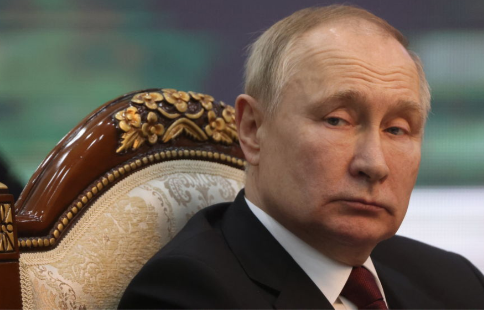 Vladimir Putin sitting in a chair