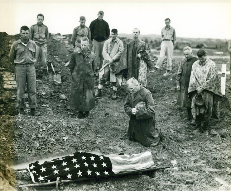 Marines paying their respect to Pfc. Mike Fenton, whose body is draped in the American flag