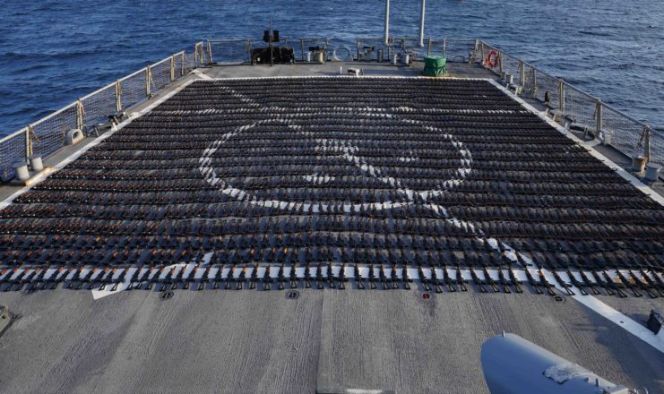 Rows of AK-47s lined up across the flight deck of the USS The Sullivans (DDG-68) 