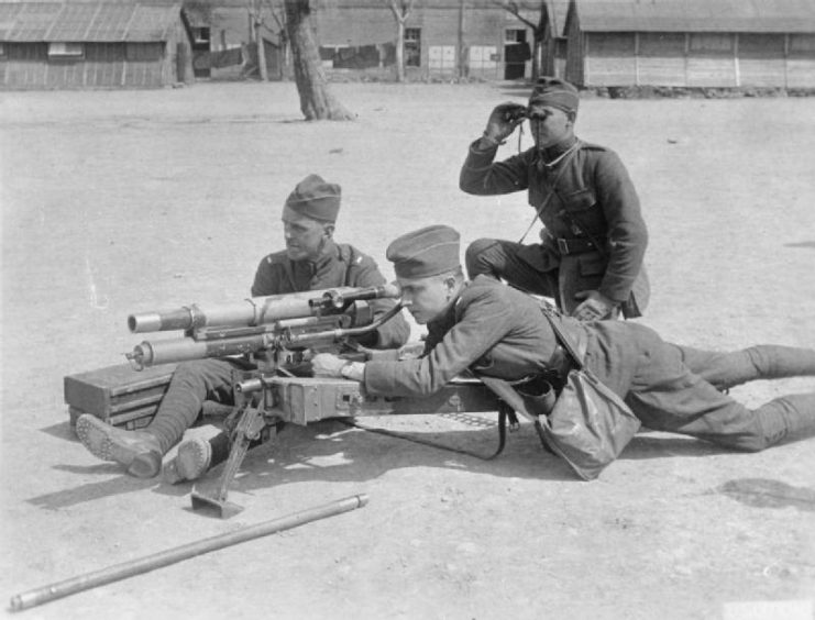 Three military personnel manning a 37 mm M1916