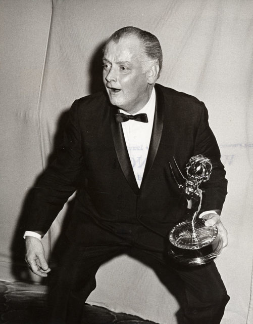 Art Carney holding an Emmy Award