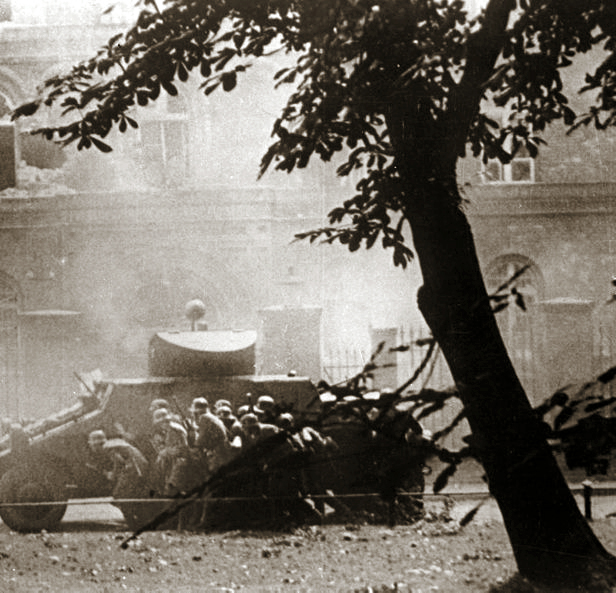 German soldiers taking cover behind an ADGZ heavy armored vehicle during the assault on the Polish Post Office