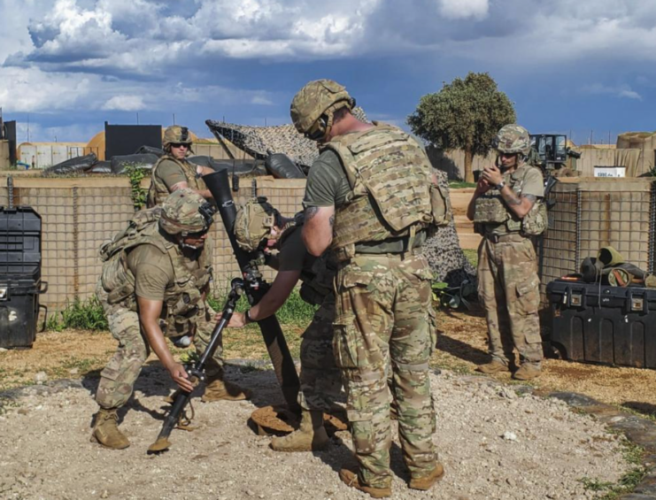 Five members of Charlie Troop, 1st Squadron, 102nd Cavalry Regiment, New Jersey Army National Guard setting up an 81 mm mortar