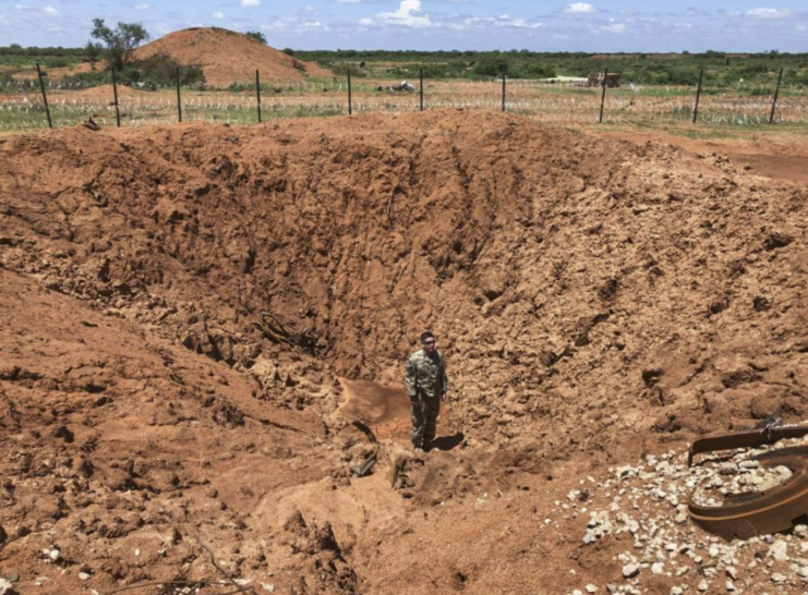 Soldier with Charlie Troop, 1st Squadron, 102nd Cavalry Regiment, New Jersey Army National Guard standing in the middle of a large crater