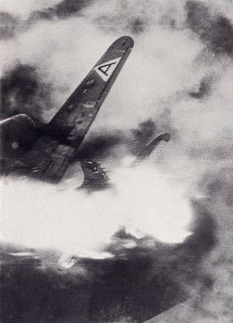 Remnants of the Boeing B-17G Flying Fortress 'Wee Willie' shrouded in flames and smoke while it falls through the sky