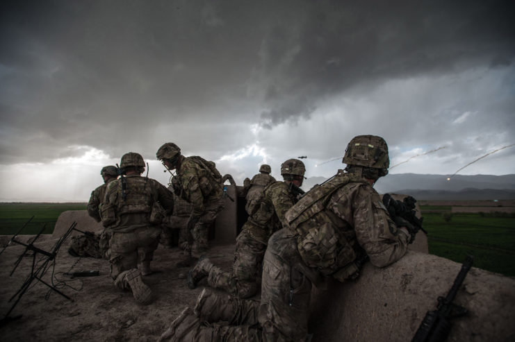 Six soldiers with "Bulldog" Company B, 1st Battalion, 187th Infantry Regiment, 3rd Brigade Combat Team "Rakkasans," 101st Airborne Division (Air Assault) positioned along a rocky ledge