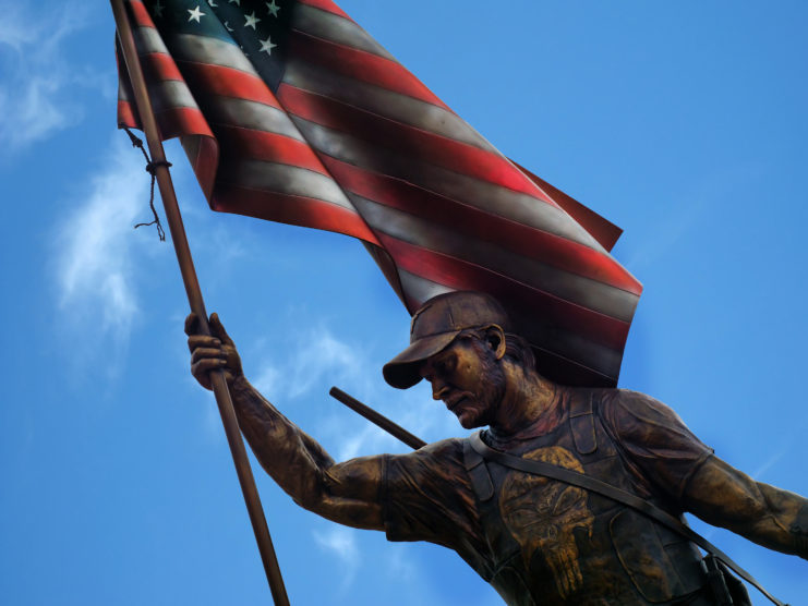 Statue of Chris Kyle holding the American flag