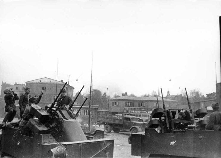 Red Army troops standing on the back of two M16 Multiple Gun Motor Carriages
