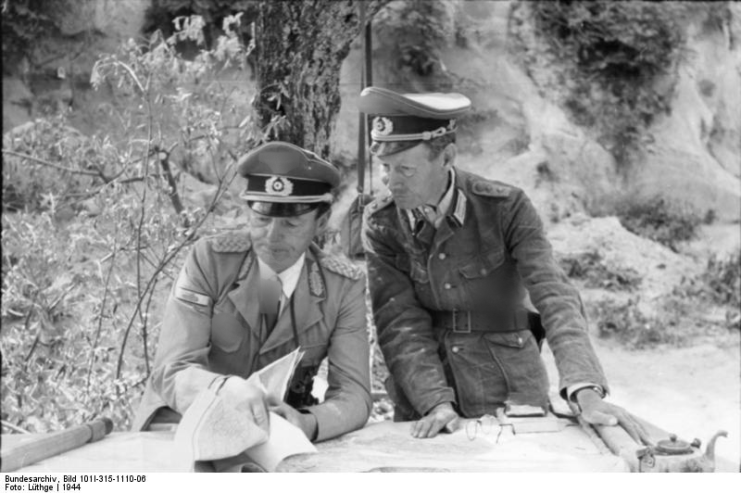 Ernst-Günther Baade and another German officer looking over documents at a table