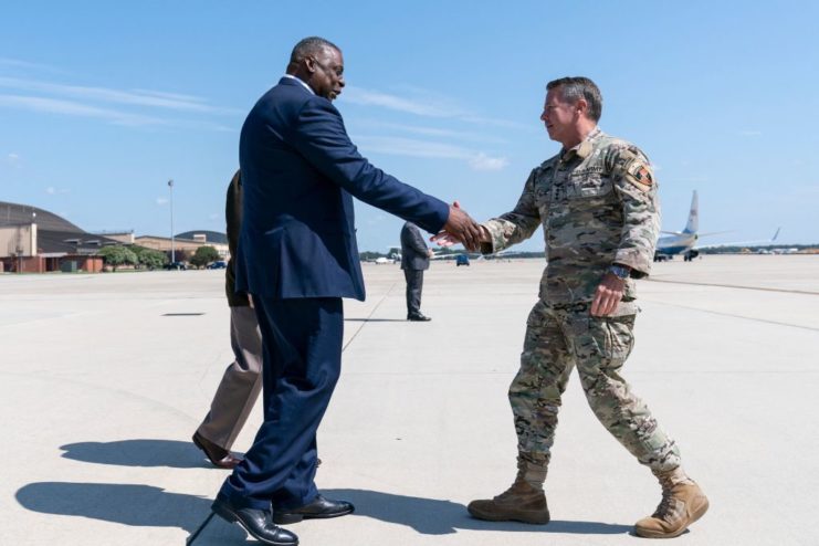 Lloyd Austin shaking hands with General Austin Miller