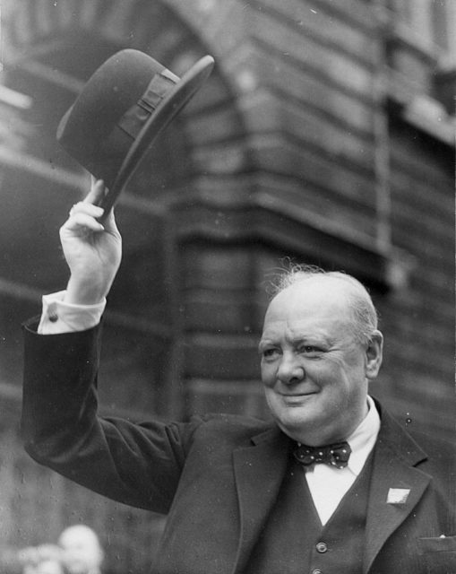 Winston Churchill tipping his hat into the air.