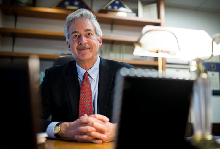 William J. Burns sitting at his desk