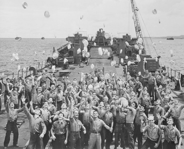 US Coast Guardsmen throwing their hats into the air