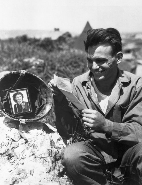 Pfc. Patrick J. Carr reading a letter