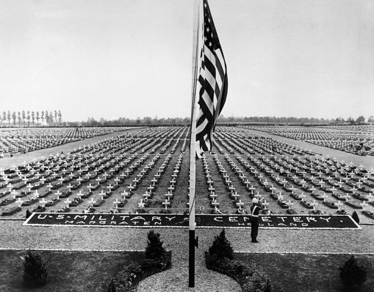 American flag flying over the graves at the Netherlands American Cemetery